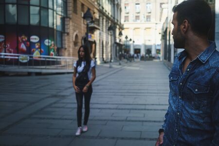 Man looking at girl on a streetの写真素材