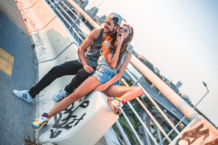 Fashionable and urban couple laughingの写真素材