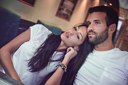 Couple in love looking trough window of a coffeeshopの写真素材