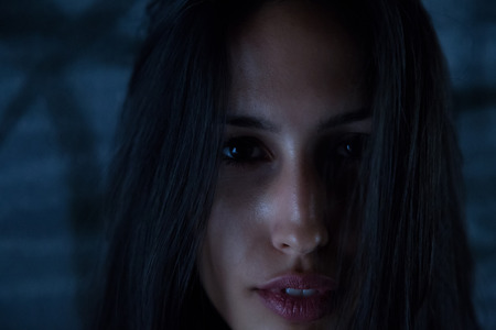 Dark haired girl looking at cameraの写真素材