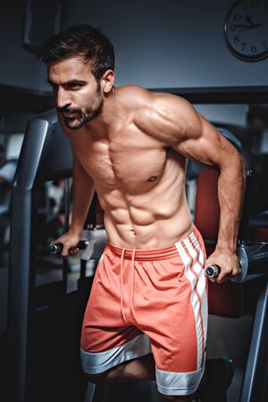 Man doing dips in the gym