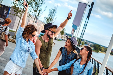 Friends put hands together and laugh. Summertime