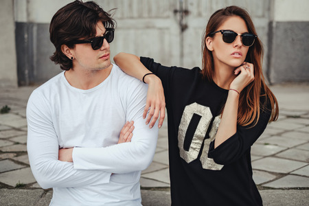 Cool couple with attitude posing outsideの写真素材