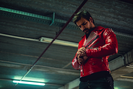 Angry man looking at the time while waiting in a garage