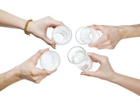 hands holding water glass cheeringの写真素材