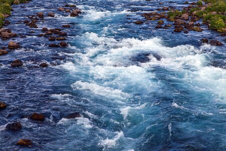 Icelandic landscape with blue water streamの写真素材