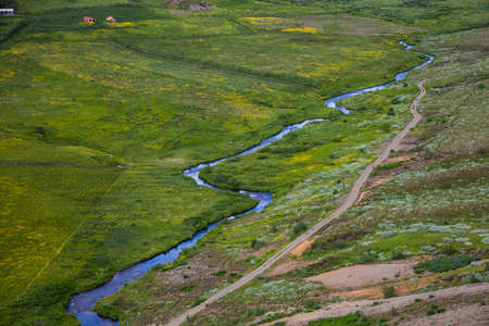 Icelandic landscape with blue water streamの写真素材