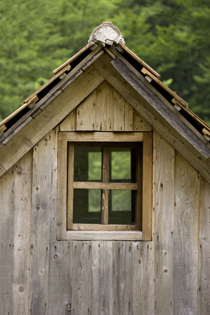 Old wooden cottage roof and windowの写真素材