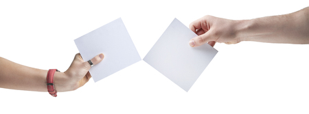 Hands holding, delivering blank piece of paperの写真素材