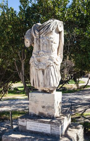 Statue of the torso of Hadrian standing in the ancient Agora of Athens, Greece. Photo shows the tunic depicting Athena standing above a she-wolf feeding Romulus and Remus.の写真素材