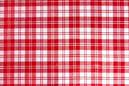 Red checkered tablecloth fabric background texture, close-up.の写真素材
