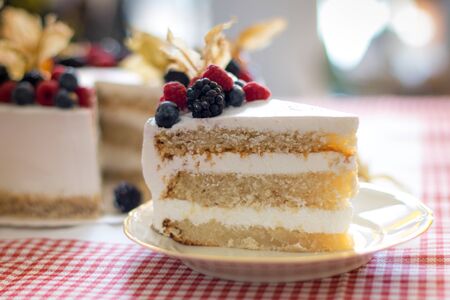 Fresh lemon pie with berries, multi-colored cream cake