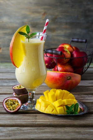 Healthy vitamin tropical mango and passion fruit smoothie with yogurt, milkshake, diet conceptの写真素材