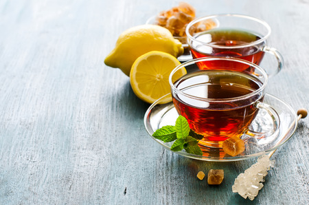 Cup of tea with mint and chrystal sugar on dark rustic copy space background, hot drinks, teatimeの写真素材