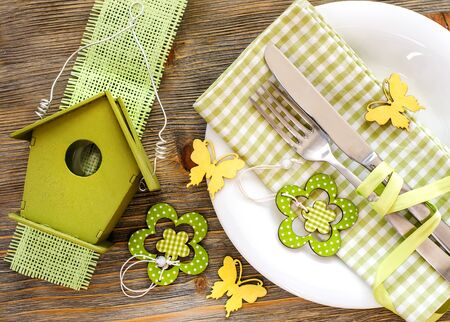 Rustic spring festive table setting with plate, napkin and tablewareの写真素材
