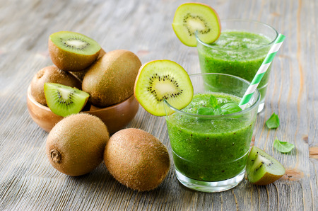 Green healthy kiwi tropical vitamin smoothie with mintの写真素材