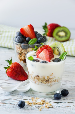 Healthy breakfast, two portions of muesli with yogurt, fruits and fresh berries, cereals, granola の写真素材