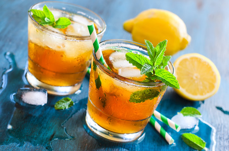 Fresh cold iced tea with mint, ice and lemons, refreshing summer drinkの写真素材