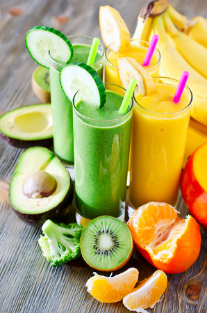 Healthy drink with fruits and vegetables on wooden tableの写真素材