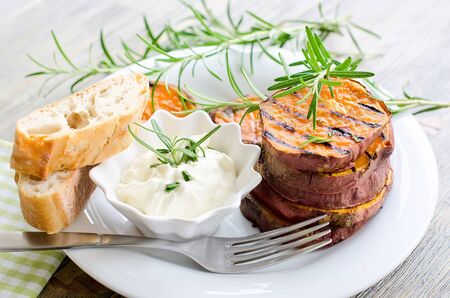 Grilled sweet potato with sauce and bread for healthy snackの写真素材