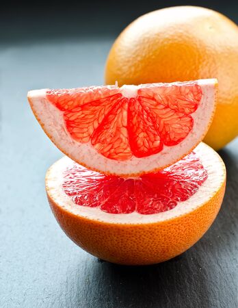 Cut red grapefruit  on dark backgroundの写真素材