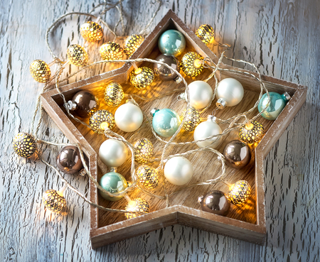Christmas star with garland lights decoration, greeting card, winter vintage backgroundの写真素材