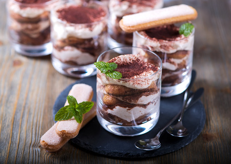Italian dessert tiramisu in glass, sweet food on white backgroundの写真素材