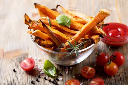 Healthy homemade sweet potato fries, vegan vegetarian snack with ketchupの写真素材