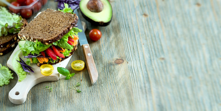 Vegan rye sandwich with fresh avocado, salad,veggies, healthy snack, vitamin and diet food copy spaceの写真素材