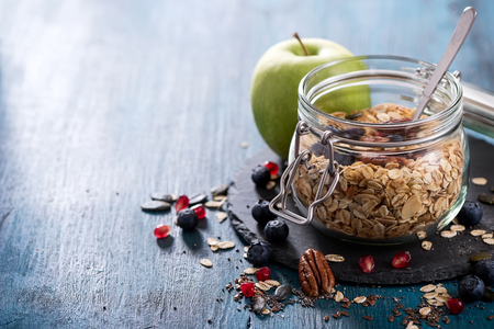 Healthy breakfast with granola or rolled oats and apple, diet conceptの写真素材