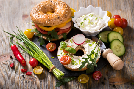 Vegetarian bagel sandwich with cream cheese fresh veggies and arugula, healthy food, lunch, breakfast,  snackの写真素材