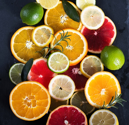 Sliced citrus fruits, vitamins, oranges, grapefruits, limes, juicy fruits backgroundの写真素材