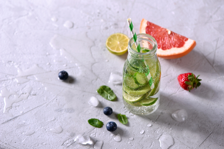 Infused detox water, healthy refreshing drink with lime, grapefruit, berries and mintの写真素材