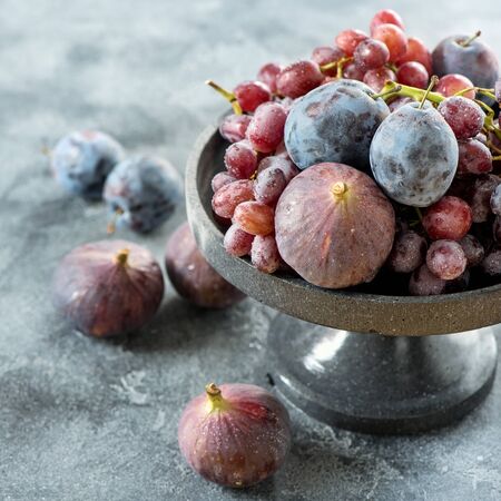 Autumn organic fruits, grapes, figs and plums, healthy vegan eating, square imageの写真素材