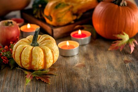 Autumn table setting with pumpkings and candles, fall home decoration for festive dinner copy spaceの写真素材