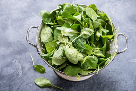 Fresh spinach leaves in a bowl, green, healthy, vegan, vegetarian ingredient for cooking, diet, vitamins, clean eating, detox food conceptの写真素材