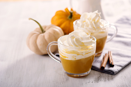 Pumpkin latte, whipped cream and spicesの写真素材