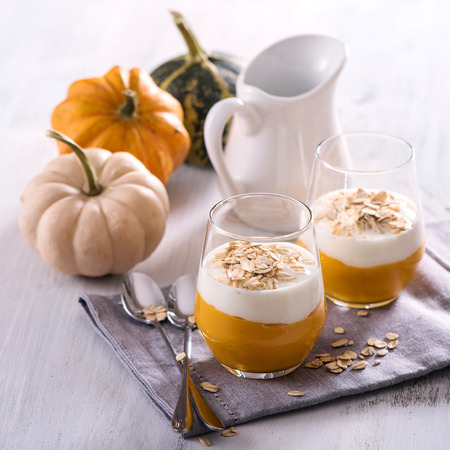 Healthy cereal breakfast with pumpkin smoothie, overnight oats, vegetarian food square imageの写真素材