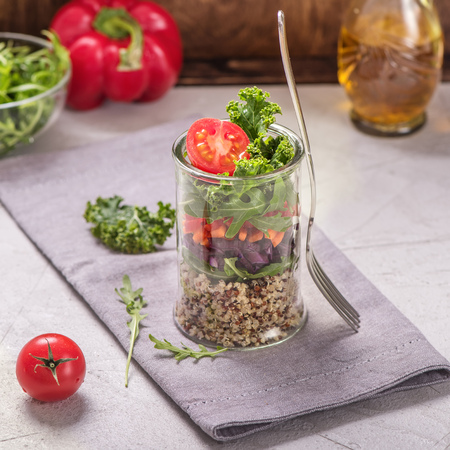 Quinoa salad in glass jar with arugula and kale, healthy snack, diet and vegan food concept, clean eatingの写真素材