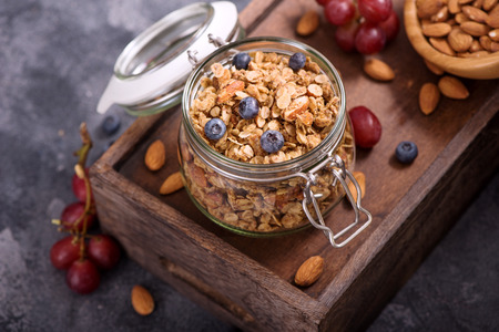 Energy snack or healthy breakfast with oats, granola or muesli with berries and nutsの写真素材