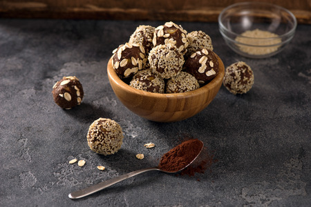 Vegan sweet bites, raw eating homemade dessert with nuts and cacao, sesam and oatsの写真素材