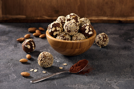 Vegan sweet bites, raw eating homemade dessert with nuts and cacao, sesam and oatsの写真素材