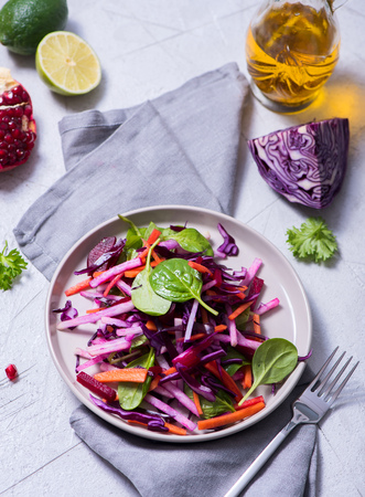 Healthy winter salad with red cabbage, carrot, beetroot, spinach, pomegranate, vitamin foodの写真素材