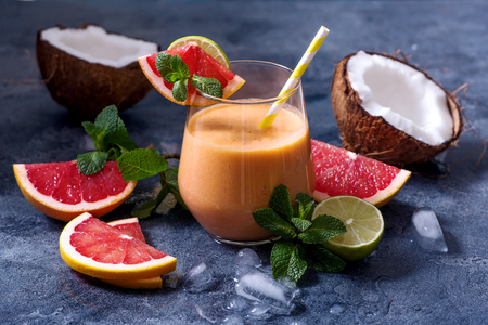 Grapefruit, pineapple, coconut cocktail, refreshing cold summer drink with ice, tropical fruit smoothieの写真素材