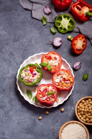 Stuffed peppers or paprika with rice and chickpeas, vegetarian lunch, vegan cooking, healthy eating, top viewの写真素材