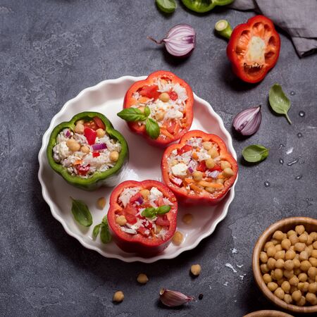 Stuffed peppers or paprika with rice and chickpeas, vegetarian lunch, vegan cooking, healthy eating, square imageの写真素材