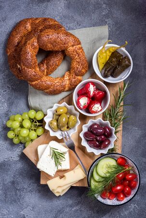 Traditional oriental snack or turkish breakfast with olives, simit bagels, feta cheese, stuffed grape leaves, top viewの写真素材