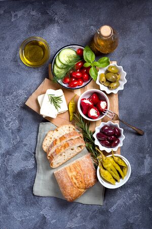 Mediterranean traditional snack with olives, pepperoni, ciabatta, olive oil,  italian or greek food concept, appetizers, antipasti, top viewの写真素材