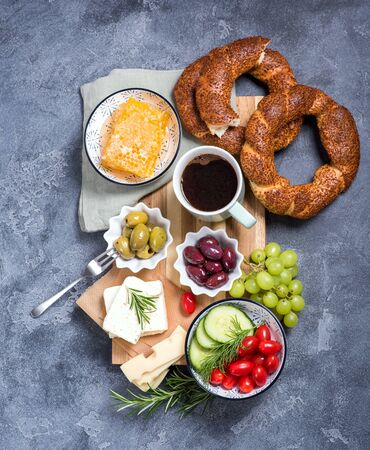 Traditional turkish breakfast with olives, simit bagels, feta cheese, cup of coffee, top viewの写真素材