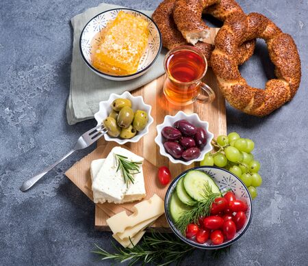 Traditional turkish breakfast with olives, simit bagels, feta cheese, tea, top viewの写真素材